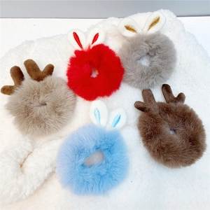 Detailed flat lay of plush rabbit ears and reindeer antlers hair rings in various colors