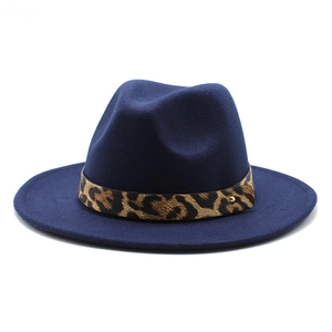 Detailed view of navy blue wool fedora featuring a leopard print band and gold stud
