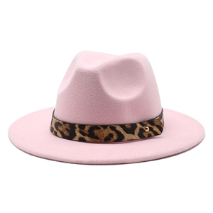 Detailed view of pink fedora hat with leopard print band and gold metal rivet accent