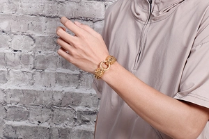 Detail of gold stainless steel lion head bracelet showing the ring clasp on a male wrist