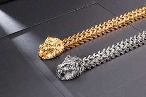 Close-up of heavy stainless steel lion head bracelets in gold and silver finish