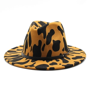 Close-up of ginger fedora hat featuring black animal print and leather belt detail