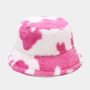 Detail of pink cow print faux fur bucket hat showing soft plush texture and pattern