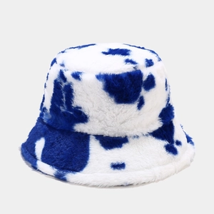 Detailed view of plush faux fur bucket hat with blue and white marble cow print texture