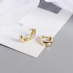 Macro shot of polished gold-finished S925 sterling silver hoop earring with inner hallmark