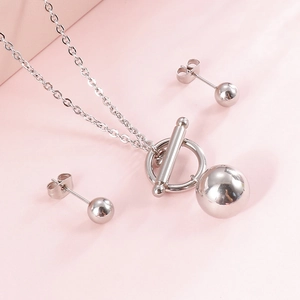 Elegant gold ball jewelry set featuring a minimalist OT buckle necklace and stud earrings