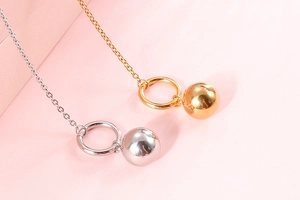 Detailed view of elegant gold and silver minimalist ball OT clasp pendant necklaces