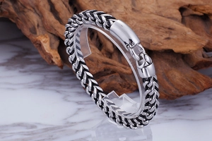Detail of woven stainless steel chain with black leather cord and large spring clasp