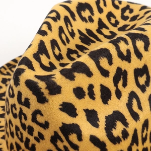 Close-up of leopard print wool felt fabric showing detailed texture and patterns