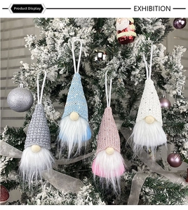 Detail showing four colorful sequined Christmas gnomes hanging on a decorated tree