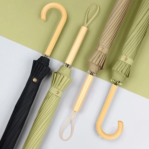 Close-up of stylish automatic umbrellas with premium wooden J-handles in various colors