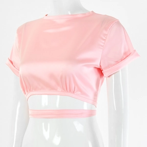 Detail of pink silk crop top showing wrap-around tie waist and hollow-out hem design
