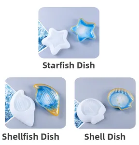 Detail of starfish, conch, and shell resin molds with gold-edged finished dishes