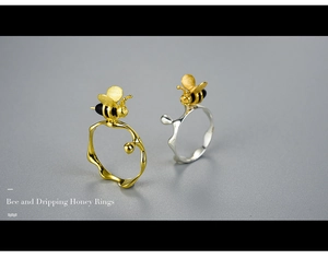 Macro detail of natural agate bee and dripping honey ring in silver and gold finish