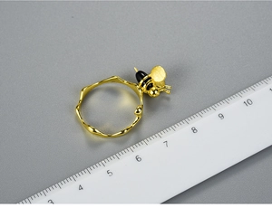 Macro detail of silver bee ring with agate and scale ruler for size reference