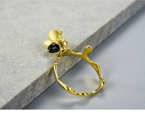 Macro shot of S925 hallmark on the gold plated bee ring with black agate beads