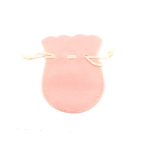 Soft pink velvet drawstring jewelry pouch with elegant ruffled edges on white background
