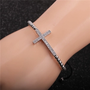Detail of adjustable beaded cross bracelet set with micro-pave zircons on a male wrist