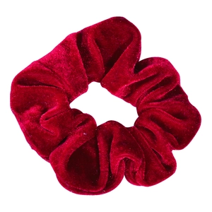 Close-up detail of a soft red velvet hair scrunchie, showing smooth texture and elastic.