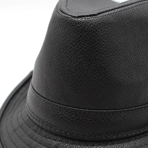 Close-up of black PU leather fedora showing detailed litchi grain and neat stitching