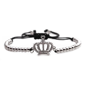 Detail of silver crown charm with micro-pave cubic zirconia and black cord bracelet