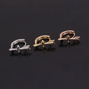 Detailed view of mini arrow-shaped cartilages hoops in silver, gold, and rose gold finish