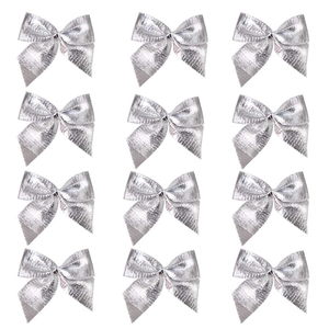 Top view of twelve glossy silver decorative bows arranged in a 4x3 grid on white background