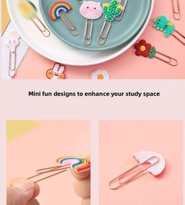 Detailed view of creative rose gold metal paperclips with colorful cartoon rubber tops