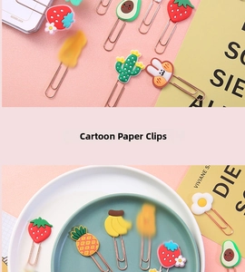 Macro shot of colorful silicone cartoon fruit and animal metal paperclips for stationery
