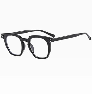 Close-up of black retro eyeglass frames with silver triple rivet detail on the temple