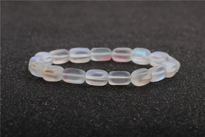 Detail of matte moonstone bracelet with iridescent glow and micro-set zircon accents