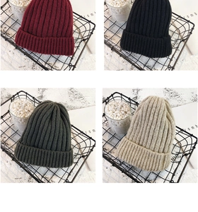Detailed close-up of ribbed knit texture in burgundy black dark green and beige colors