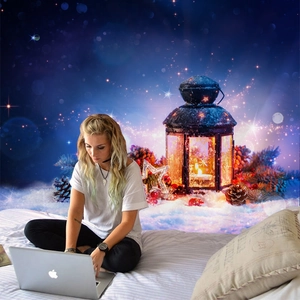 Detail of Christmas wall tapestry featuring a vintage lantern in snowy night star scene