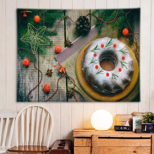 Detail of Christmas wall tapestry featuring festive cake and pine branches in cozy room