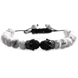 Detailed view of 8mm white turquoise and black volcanic lava beads with crown charms