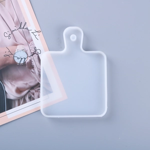 Close-up of translucent silicone mold in mini chopping board shape with hanging hole