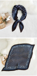 Detailed view of pleated silk scarf with navy and brown paisley pattern texture