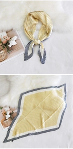 Detail of pleated silk scarf featuring yellow houndstooth pattern and crinkled edge texture