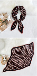 Detailed view of red and black geometric pleated scarf with wavy edges on white fur background