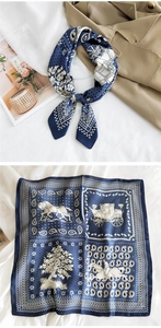 Detail of blue and beige silk scarf with vintage horse carriage and paisley patterns