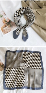 Detail view of a 3D geometric pattern silk scarf with a polished satin finish