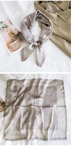 Detail of silk square scarf featuring elegant line art pattern and striped borders