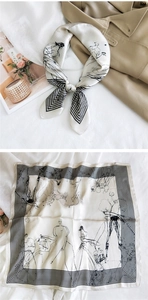 Close-up of a square silk scarf with black sketch prints and smooth satin texture