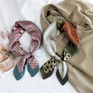 Elegant satin silk square scarves with geometric and leopard prints on trench coat