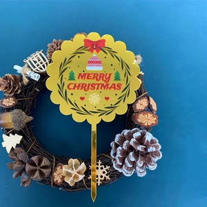 Golden Merry Christmas acrylic cake topper with festive tree and pine cone wreath