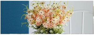 Detail of vibrant artificial daisy bouquet with orange and white silk petals in a home setting