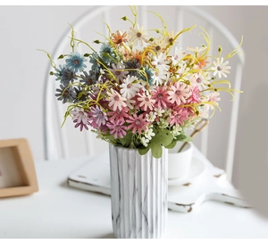Colorful artificial daisies in a white marble vase for Nordic style home decoration