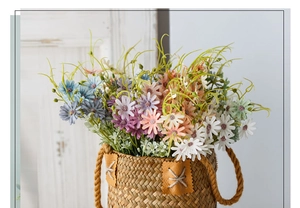 Artificial multicolor daisies in a woven brown basket against a white wooden door