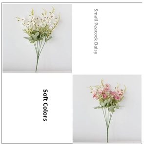 Detail of white and pink faux peacock daisies with natural green leaves and stems