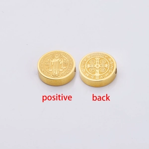 Detailed front and back view of golden Saint Benedict medal charms for DIY jewelry making